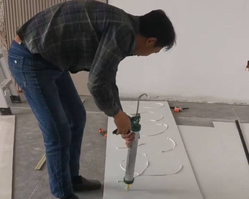 Marble Carbon Crystal Wall Panel 18 Carbon Crystal Wall Panel installation Step 2 applying adhesive or click system for WPC interior wall panel installation