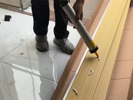 WPC fluted wall panel installation process applying structural adhesive on the back of wall panel for strong bonding interior wall cladding system